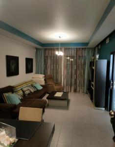 a living room with a couch and a tv at Casa Pablo Picasso 9 in Jimena de la Frontera