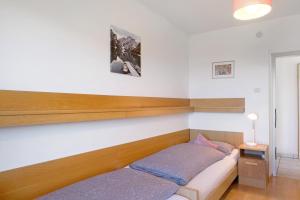 a bedroom with two beds and a night stand at Apartment Rosengartenblick in Steinegg