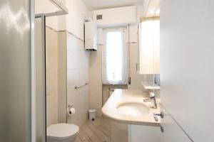 a bathroom with a sink and a toilet at Il Corallo in Albisola Superiore +15 photos