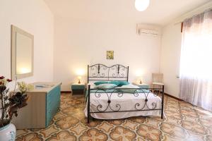 a bedroom with a bed and a dresser in it at Casa Isabel a Otranto 10 posti in Otranto