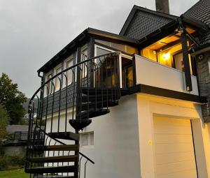 a house with a staircase leading up to a garage at Ferienwohnung Blum in Schmallenberg