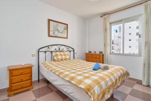 a bedroom with a bed and a window at Apartmento Los Alamos in Nerja