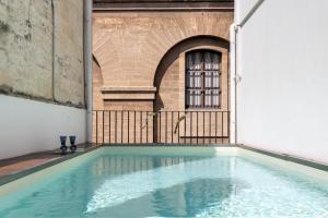 a swimming pool in the middle of a building at Palazzo P D'ajmo - Dimora Storica in Lecce