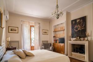 a bedroom with a bed and a fireplace at Palazzo P D'ajmo - Dimora Storica in Lecce +37 photos