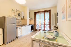 a kitchen with a table and a refrigerator at La Terrazza in Brunate