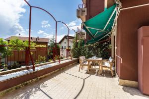 a balcony with a table and a green umbrella at La Terrazza in Brunate +15 photos