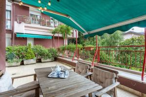 a wooden table and chairs on the balcony of a building at La Terrazza in Brunate