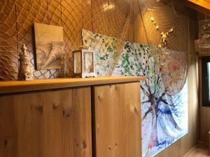 a room with a wooden shelf with a painting on the wall at Ferienwohnung Borkum in Burhave