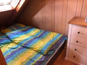 a small bedroom with a bed and a dresser at Ferienwohnung Borkum in Burhave