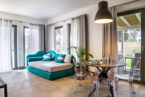 a living room with a couch and a table at Casale Lorenzo Appartamenti in Orbetello