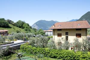 a house in a village with mountains in the background at Il ponte dei sogni in Brescia