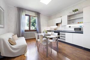 a kitchen and dining room with a table and chairs at Il ponte dei sogni in Brescia