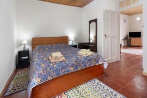 a bedroom with a bed with a phone on it at A Casa d'Amália in Ginetes