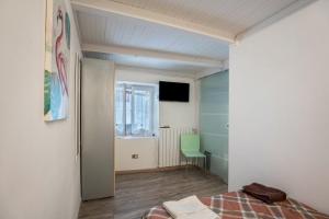 a bedroom with a bed and a room with a window at Casa Giulia Balmuccia in Balmuccia