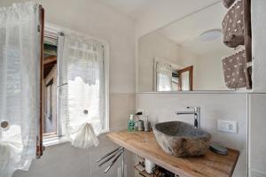 a bathroom with a stone sink and a window at Casa Giulia Balmuccia in Balmuccia +21 photos
