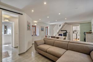 a living room with a couch and a staircase at Casa Giulia Balmuccia in Balmuccia