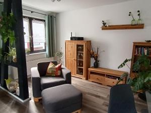 a living room with a couch and a chair at Ferienwohnung Papperitz in Heiligen