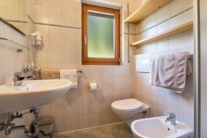 a bathroom with a sink and a toilet at Kranebitterhof Apt Alpenrose in Valdaora +27 photos