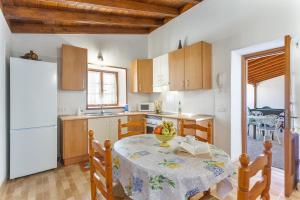 a kitchen with a table with a book on it at Las Casas del Bisa in Garachico +17 photos