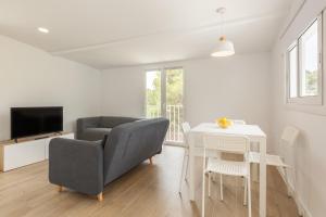 a living room with a couch and a table at Casita Palmeras in Canyelles