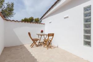 a patio with a table and two chairs at Casita Palmeras in Canyelles