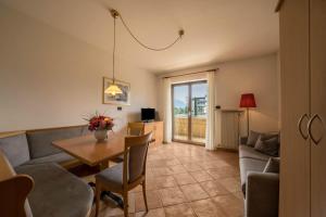 a living room with a table and a couch at Weinsepphof Ferienwohnung 3 in Lana