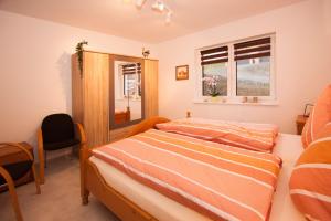 a bedroom with a bed and a window at Ferienwohnung Mertens in Schmallenberg