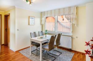 a dining room with a table and chairs at Ferienwohnung Inge in Uder