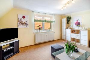 a living room with a large flat screen tv at Ferienwohnung Inge in Uder