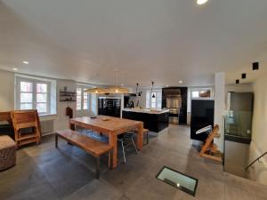 a kitchen with a wooden table and a dining room at Villa lavaudieu in Lavaudieu