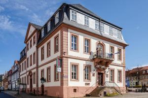 a large white building with a balcony on a street at Ferienwohnung Inge in Uder