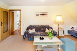 a living room with a couch and a table at Ferienwohnung Inge in Uder