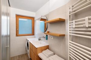 a bathroom with a sink and a mirror at Chalet Emma Isolaccia in Valdidentro +16 photos