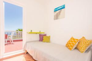 a bedroom with a bed and a balcony at Buena Ventura Villa in Cala en Bosc