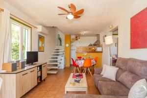 a living room with a couch and a table at Buena Ventura Villa in Cala en Bosc