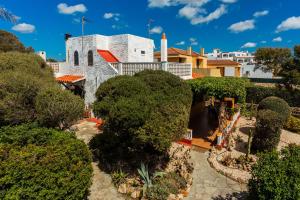 a view of the building from the gardens at Buena Ventura Villa in Cala en Bosc