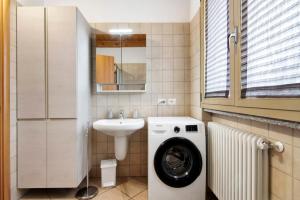 a bathroom with a washing machine and a sink at Casa Zia Dani in Piantedo +17 photos