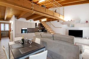 a dining room and kitchen with a table and chairs at Casa Zia Dani in Piantedo