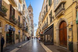 a city street with buildings and a clock tower at Málaga Dream Apartment in Málaga