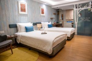 a hotel room with two beds and a chalkboard at Sojourn Spa Hotel Kuala Lumpur in Kuala Lumpur
