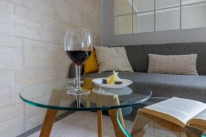 a glass of wine on a glass table in a living room at Málaga Dream Apartment in Málaga