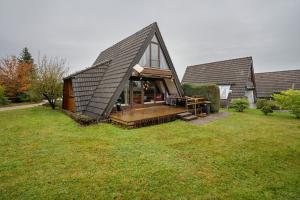 a small house with a pitched roof on a field at Ferienhaus Bussardnest in Tennenbronn