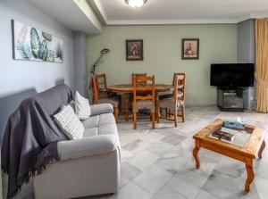 a living room with a couch and a table at Fantastic beachfront apartment in Estepona