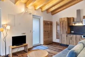 a living room with a couch and a tv at Ferienwohnung Grubig in Ehrwald