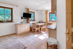 a kitchen and dining room with a table and a television at Ausser Brugghof in Senales +54 photos