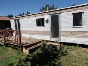 a mobile home with a porch and a deck at Mobil'Home du Sancillon in Charentay