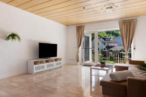 a living room with a flat screen tv on a wall at Casa Conte in Mörlenbach