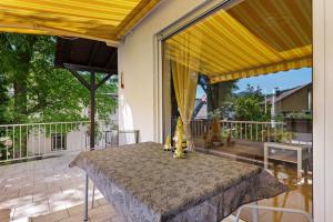 a table on a patio with a yellow canopy at Casa Conte in Mörlenbach