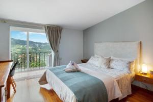 a bedroom with a bed with a large window at Carmelo y Carmela 4 in Teror