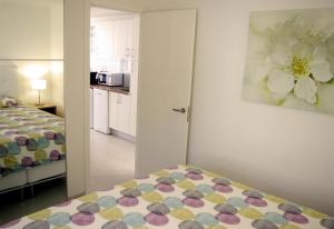 a small bedroom with a bed and a kitchen at Fabulous upper floor sea view in San Agustin +36 photos